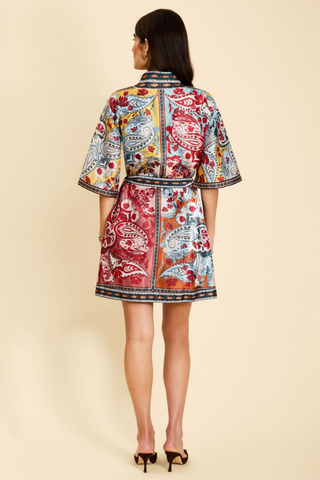 Mestiza Aracati Mini Dress in Venetian Patchwork featuring a colorful mixed print, mandarin collar, three-quarter sleeves, and self-tie waist.