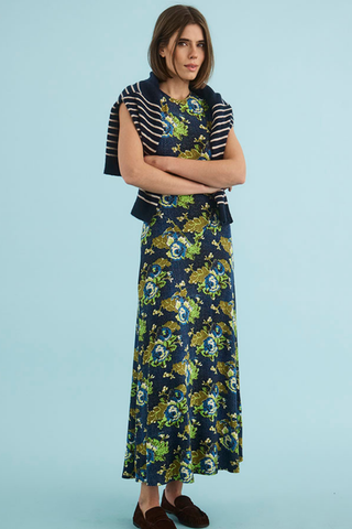 Hunter Bell Barker Dress in Primrose featuring a colorful floral print, sleeveless bodice, and flowing maxi-length silhouette.