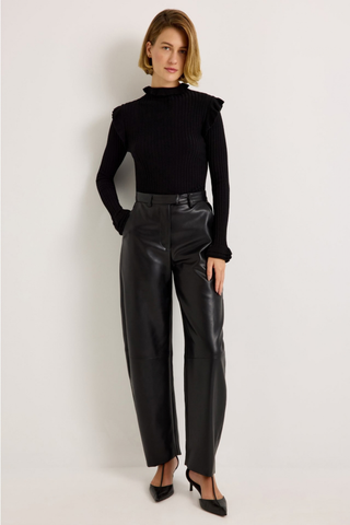 Marie Oliver Harlow Pant in Black featuring sleek vegan leather, a fitted waist, and modern barrel-leg silhouette.