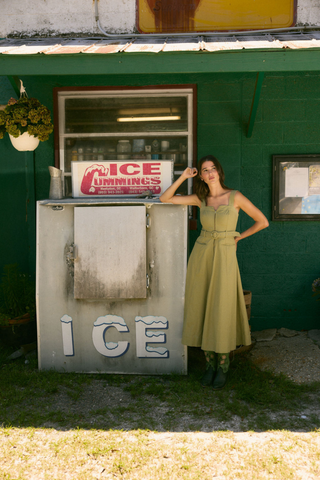 Olivia by Livro Foster Dress in Olive featuring a sleeveless midi silhouette, waist tie, and full skirt.