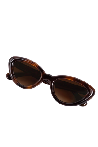Krewe Sasha Sunglasses in Maple featuring a glossy brown cat-eye acetate frame and amber gradient lenses.