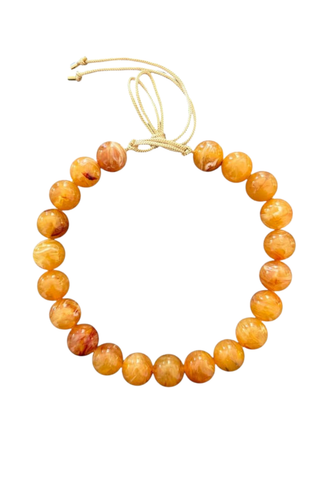 KMS Gems Chunky Beaded Necklace in Sunset Citrine featuring oversized golden yellow and amber marbled beads with an adjustable gold silk cord.