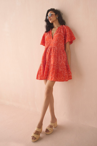 Omika Hadley mini dress in orange Uma Persimmon print with tiered skirt and tie neckline
