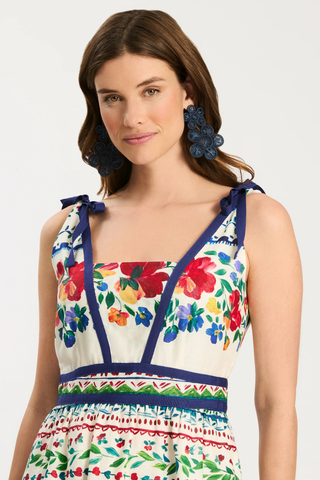 Woman wearing a colorful floral dress with a white background