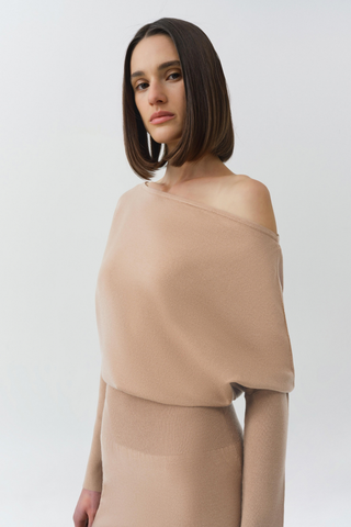 SIMKHAI Janese Off Shoulder Midi Dress in Camel featuring a wide off-the-shoulder neckline, fitted waist, and straight midi skirt.