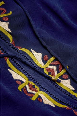 Marie Oliver Royce Blouse in Sundown featuring deep navy fabric, colorful embroidery, a tie neckline, and billowy sleeves.