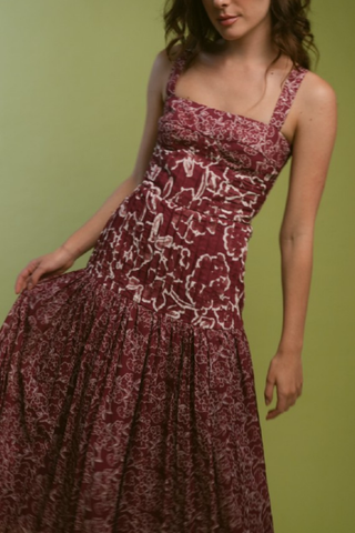 Red floral midi dress with a fitted bodice and flowing skirt.