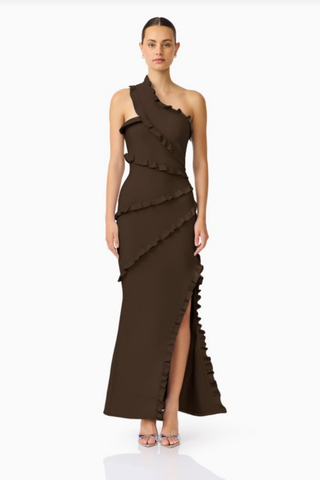 Elliatt Floriana Asymmetric Neck Gown in Brown with one-shoulder neckline, cascading ruffle detailing, floor-length skirt, and thigh-high side slit.