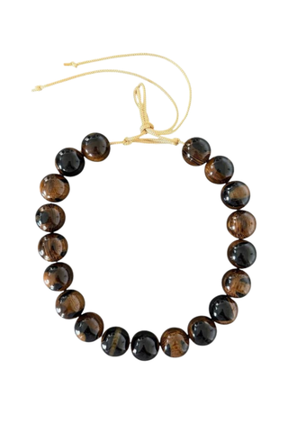 KMS Gems Chunky Beaded Necklace in Woodgrain featuring oversized marbled brown and black beads with an adjustable silk cord.