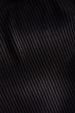 Marie Oliver Tinley Turtleneck in Black featuring fine ribbing, a fitted silhouette, fold-over ruffle neck, and ruffled cuffs.