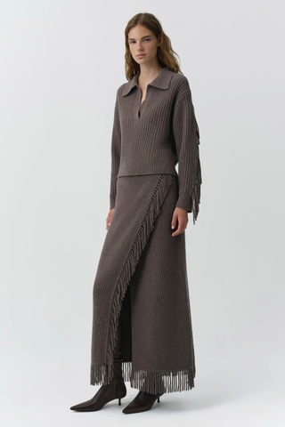 SIMKHAI Casey Midi Skirt in mushroom brown knit with a faux-wrap silhouette and fringe trim along the edge and hem.