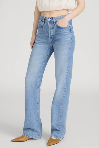 Model wearing FRAME The Vertical Jean in Static, a high-rise straight-leg rigid denim jean in a light vintage wash