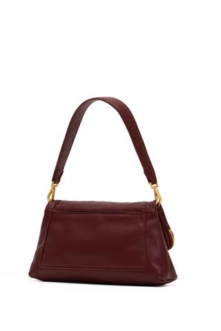 Hammitt Beverly Med Handbag in Cherrywood Pebble featuring deep oxblood leather, brushed gold hardware, and an elongated convertible silhouette.