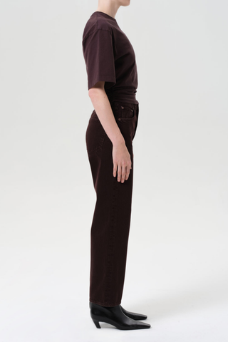Model wearing the AGOLDE Ren Jean in Sloe Berry featuring a high-rise waist, cropped wide-leg silhouette, and rich dark grape denim with warm brown undertones.