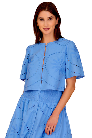 Blue eyelet cropped blouse with short sleeves and front slit detail paired with matching midi skirt