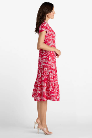 Woman wearing a red floral dress on a white background