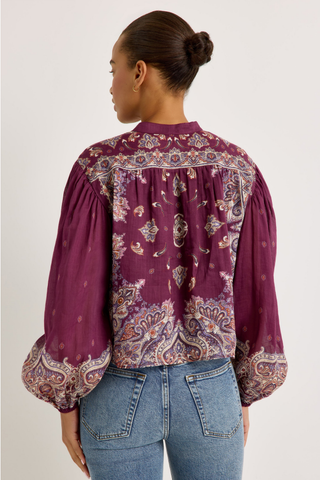 Rhiannon Top in Majesty featuring a rich purple paisley print, stand collar, button front, and full gathered long sleeves.
