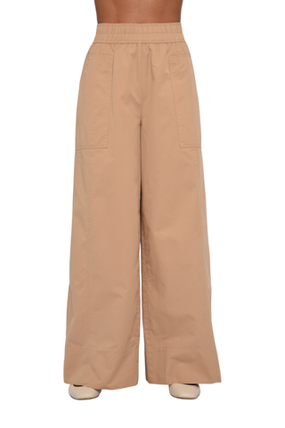 Model wearing the Love the Label Ramona Pant in Sand Dust featuring a high-rise waist and wide-leg silhouette.