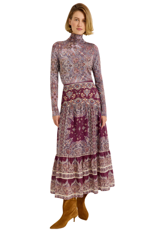 Holland Skirt in Majesty featuring a purple and neutral paisley print, fitted drop waist, and flowing tiered midi silhouette.