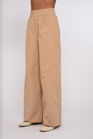 Model wearing the Love the Label Ramona Pant in Sand Dust featuring a high-rise waist and wide-leg silhouette.