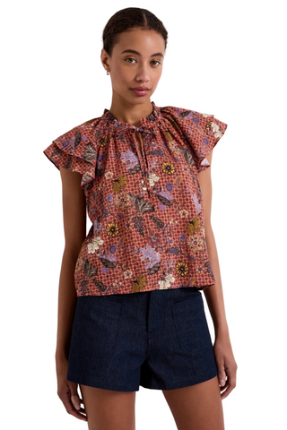 Marie Oliver Hartley Top in Cassia featuring a colorful floral print, flutter sleeves, and adjustable tie neckline with beaded ends.