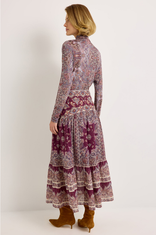 Holland Skirt in Majesty featuring a purple and neutral paisley print, fitted drop waist, and flowing tiered midi silhouette.