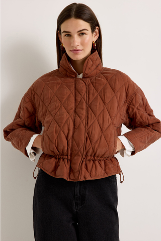 Marie Oliver Haisley Jacket in Tortoise featuring a quilted rust-brown design, funnel neckline, and adjustable drawstring waist.