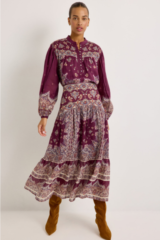 Holland Skirt in Majesty featuring a purple and neutral paisley print, fitted drop waist, and flowing tiered midi silhouette.