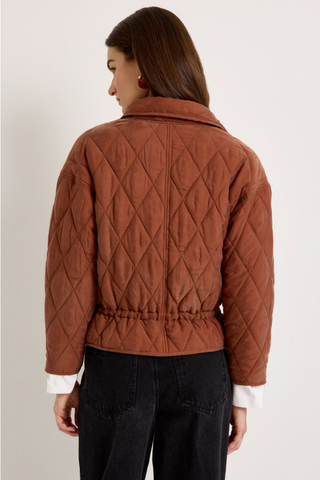 Marie Oliver Haisley Jacket in Tortoise featuring a quilted rust-brown design, funnel neckline, and adjustable drawstring waist.