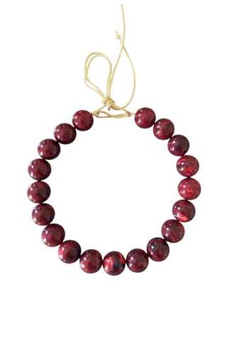 KMS Gems Chunky Beaded Necklace in Marbled Garnet featuring oversized marbled burgundy and garnet-colored beads with an adjustable gold silk cord.
