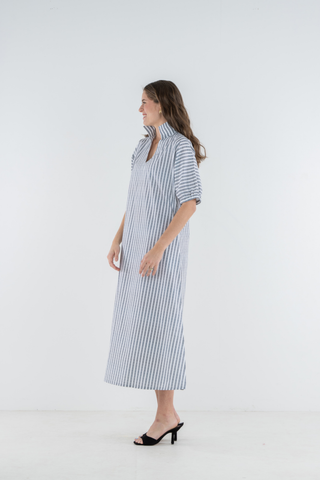 Model wearing the Emily McCarthy Poppy Maxi in Black Stripe with a relaxed maxi-length silhouette.