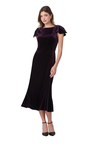 Shoshanna Brandis Dress in Dark Plum featuring stretch velvet, a boat neckline, draped bow shoulders, fitted bodice, and softly flared midi skirt.