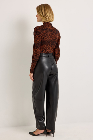 Marie Oliver Harlow Pant in Black featuring sleek vegan leather, a fitted waist, and modern barrel-leg silhouette.