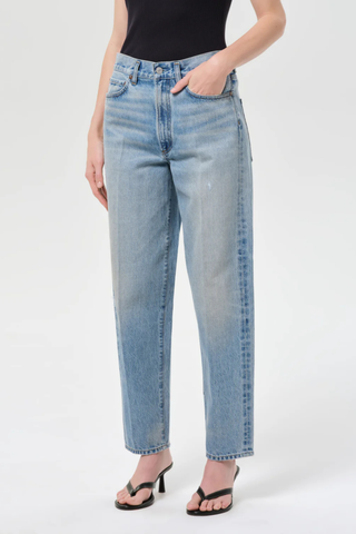 Model wearing AGOLDE The 80’s Jean in Orbital, a high-rise straight-leg rigid denim jean in a medium vintage indigo wash