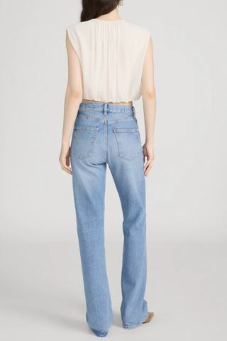 Model wearing FRAME The Vertical Jean in Static, a high-rise straight-leg rigid denim jean in a light vintage wash