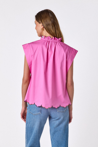 Model wearing the Crosby Fritzy Top in Poppy Pink with cap sleeves and a relaxed silhouette.