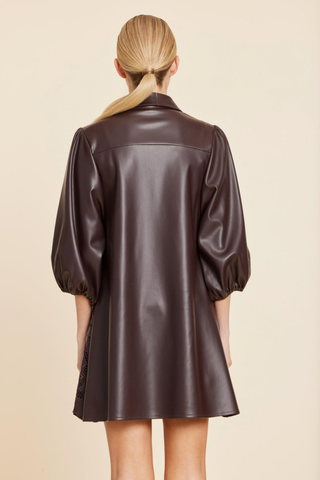 Dolce Cabo Laser Cut A-Line Dress in Coffee featuring brown faux leather, floral cutout detailing, puff sleeves, and an A-line mini silhouette.