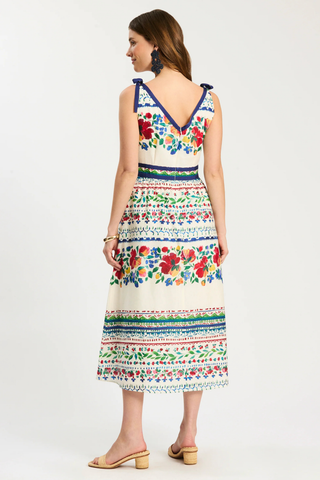 Woman wearing a colorful floral dress on a white background
