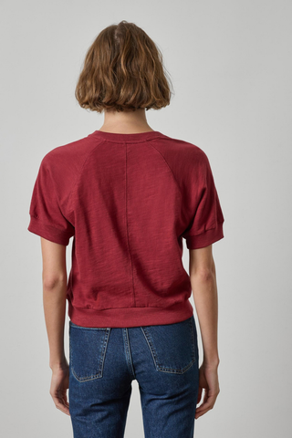 Woman wearing the Lilla P Vintage Short Sleeve Raglan Tee in Cabernet, a relaxed burgundy cotton crewneck tee.