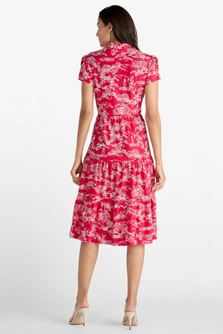 Woman wearing a red floral dress on a white background