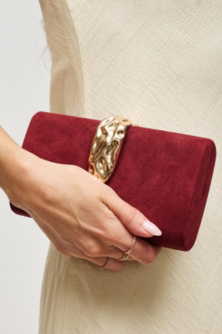 Urban Expressions Babe Clutch in Burgundy featuring a rich suede-effect exterior, sculptural hammered metal clasp, and removable chain strap.