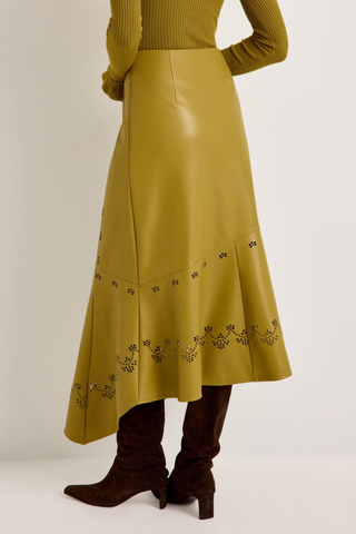 Marie Oliver Casey Skirt in Willow featuring vivid chartreuse vegan leather, laser-cut floral details, and an asymmetrical midi hem.