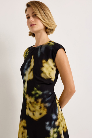 Marie Oliver Zuri Dress in Lush featuring oversized golden florals on a black background with a fluid sleeveless maxi silhouette.