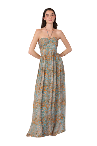 Woman wearing a strapless, long, patterned dress on a white background