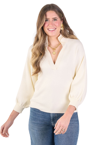 Emily McCarthy Lolli Sweater in Sandshell, a cream long sleeve sweater with a stand collar, V-neckline, and blouson sleeves.