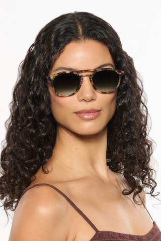 Krewe Markle Sunglasses in Tuscan Tortoise featuring a rounded tortoise acetate frame, gold-tone metal bridge, and dark green gradient lenses.