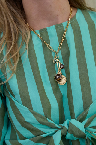 Mignonne Gavigan Onda Necklace in Gold featuring a delicate gold-plated chain with tiger's eye, mother-of-pearl, glass, and crystal charms.