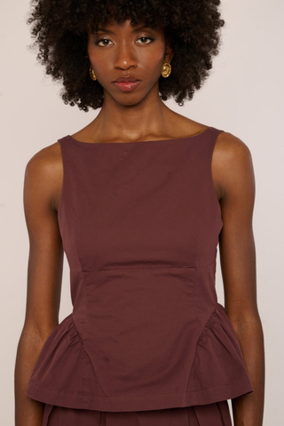 Love the Label Earnshaw Top in Deep Mahogany featuring a sleeveless fitted bodice with a softly flared peplum-style hem.