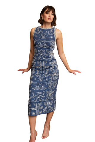 Woman wearing a navy blue midi dress against a white background.