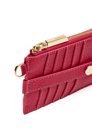 Red wallet with gold zipper and accents on a white background